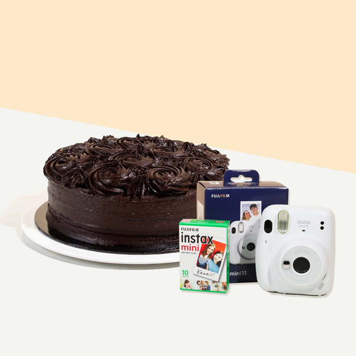 Chocolate cake coated head to toe with smooth chocolate cream, decorated with chocolate swirls with an Instax Camera and film
