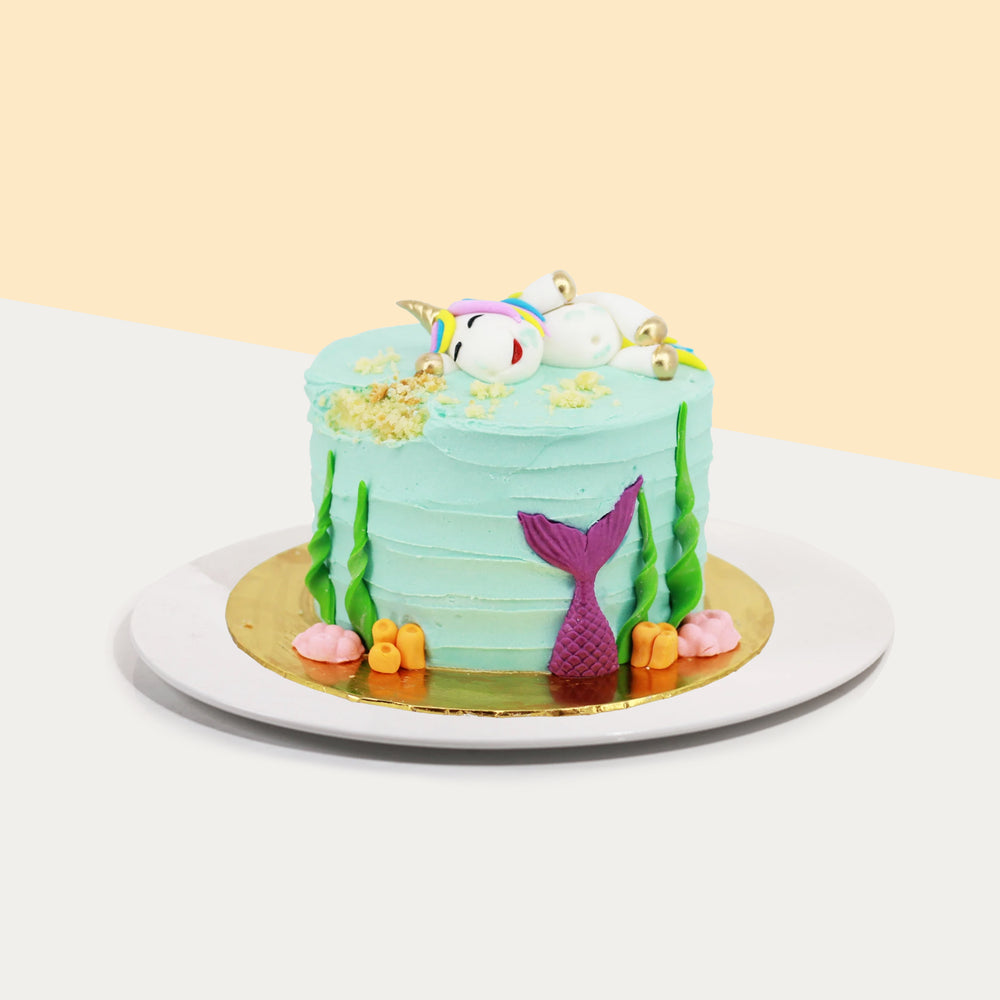 Butter cake with a drunk unicorn on top which has stolen a bite of cake