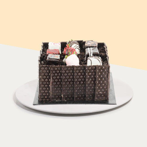 French chocolate box with chocolate cake, chocolate ganache layers, hazelnut praline