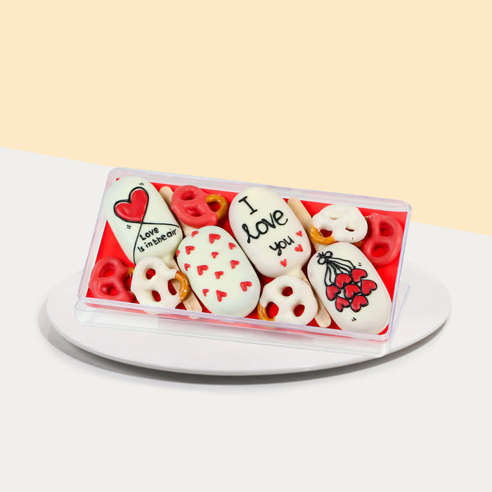 Cake pops with white hard shells, decorated with love elements