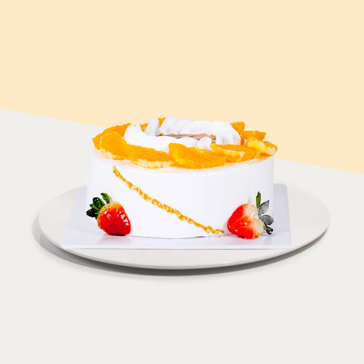 Vanilla chiffon cake topped with fresh orange slices and strawberries