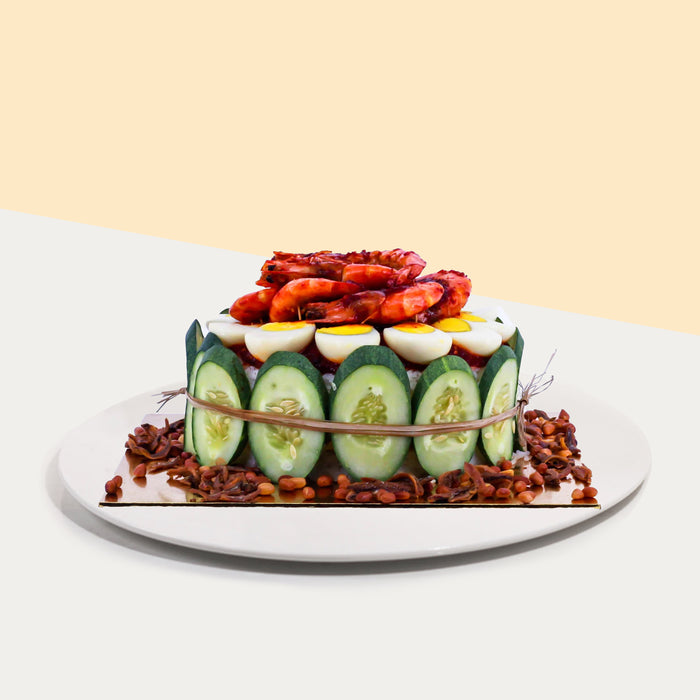 Nasi lemak cake with nuts, anchovies, cucumber slices, boiled eggs and large prawns