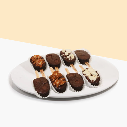 Brownie cake pops topped with salted caramel walnut, chocolate chips and chocolate almonds