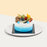 Blue and white cream frosted cake, with mango fillings, topped with macarons and fresh fruits