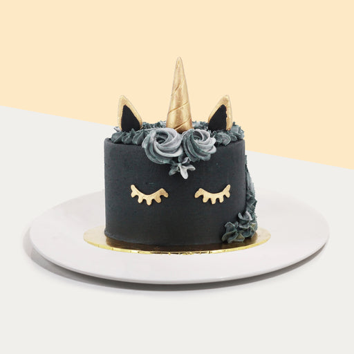 Black buttercream unicorn cake with grey cream cream swirls