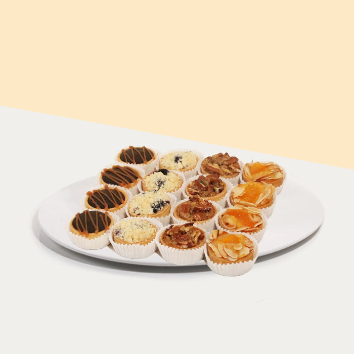 Mixed box of tarts with salted caramel chocolate, butterscotch pecan, blueberry crumble and mandarin orange almond