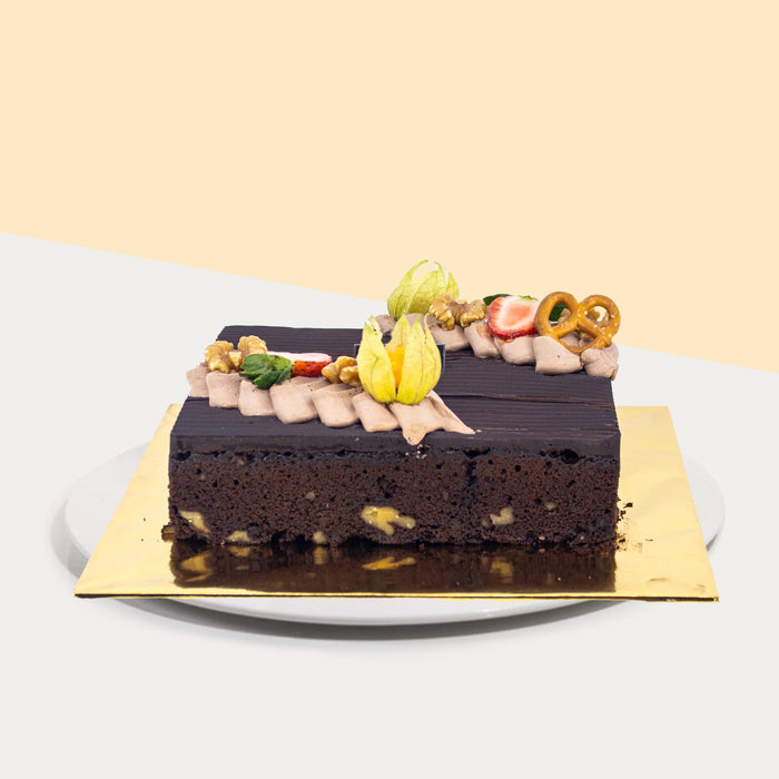 Chocolate brownies with walnuts, topped with chocolate ganache and fresh fruits
