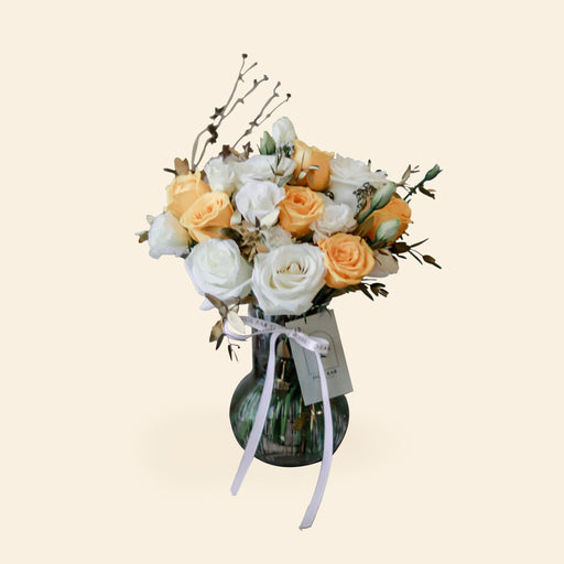 Flower bouquet in a vase with Yellow Roses, White Limonium and foliages
