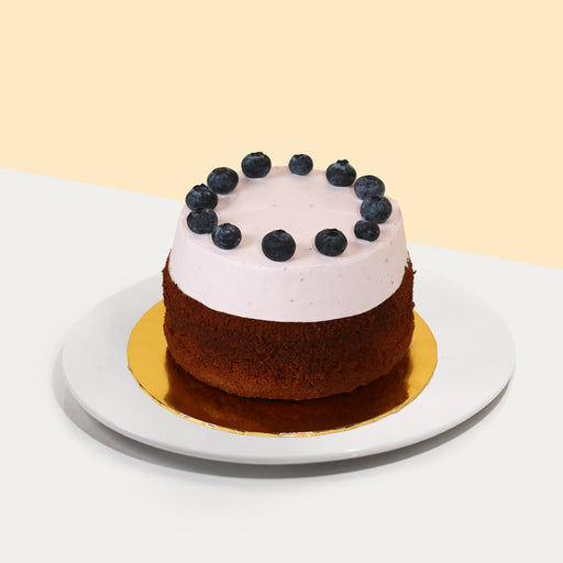 Blueberry butter cake, topped with blueberry cream and fresh blueberries