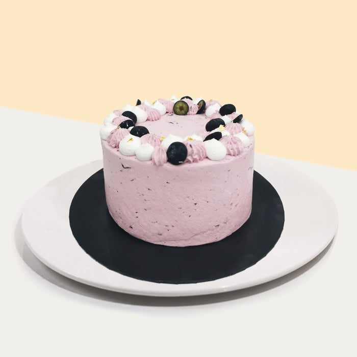Earl grey sponge cake, layered with blueberry cream, topped with cream and blueberries