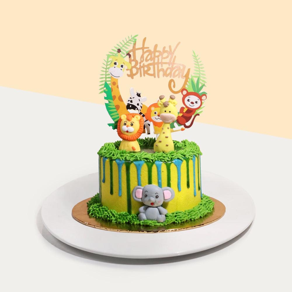 Safari themed cake with fondant animals, and a Happy Birthday topper