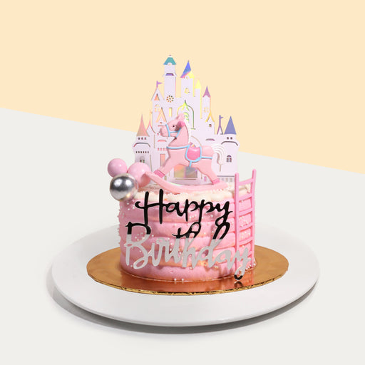 Pink rocking horse themed cake with a 2d printed castle background