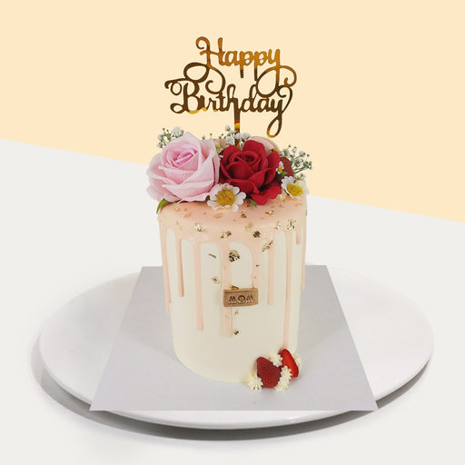 Flower themed cake with fresh cream, strawberry drip, and faux roses