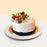 Vanilla sponge cake with black sesame paste, topped with walnuts, pretzels, kiwi and strawberries