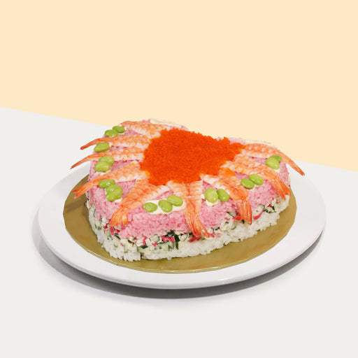 Heart shaped sushi cake topped with edamame, prawns and prawn eggs
