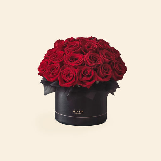 Red roses within an ebony black box
