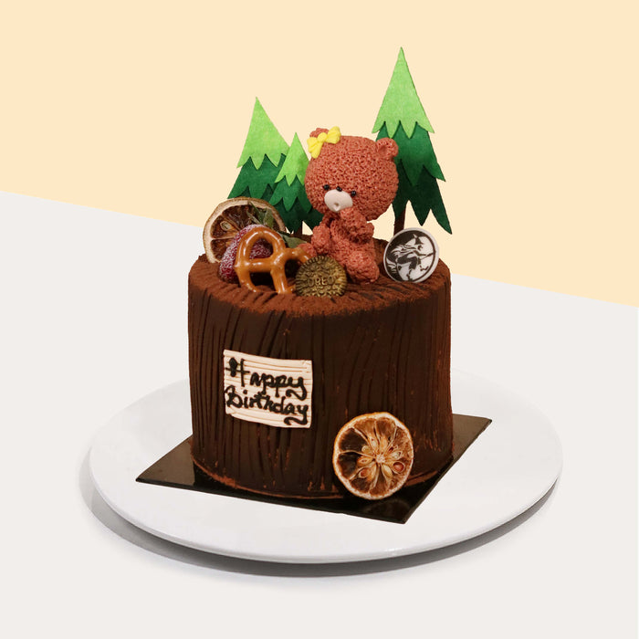 Chocolate sponge cake with chocolate cream, with a bear figurine decoration