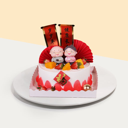 Sponge cake with red cream swipes, with grandpa and grandma figurines