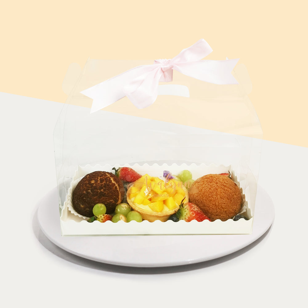 Treat box with a mango tart, Vanilla Profiterole, Chocolate Profiterole and Assorted Fruits 