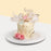 Buttercake with buttercream, with fresh flowers, decorative balls, feathers and 2d butterflies