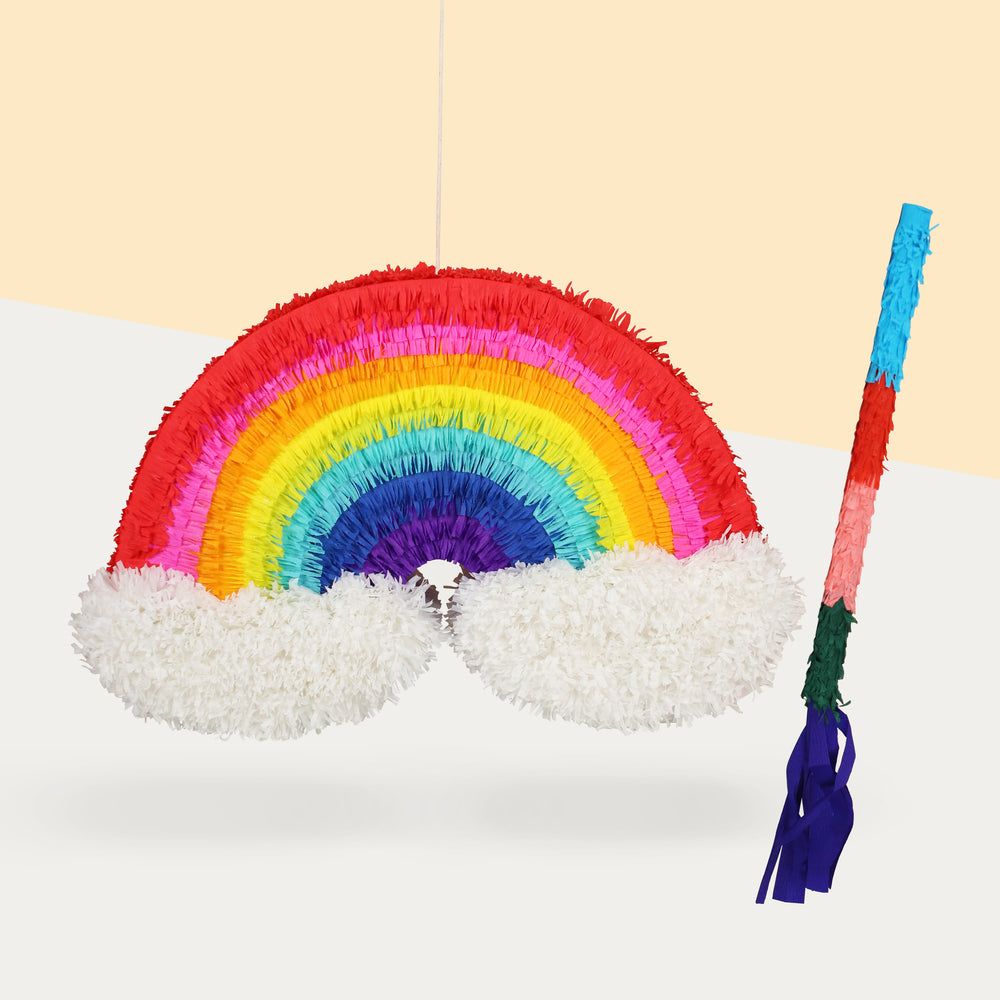 Rainbow pinata with a stick, filled with candy