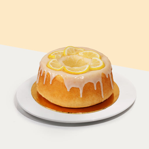 Lemon chiffon cake topped with fresh lemon slices, glazed with sugar