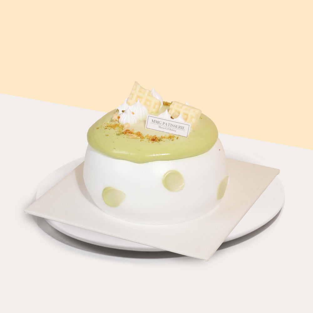 Jasmine green tea chiffon sponge with longan infused cream and cubes, topped with a dollop of whipped cream and white chocolate