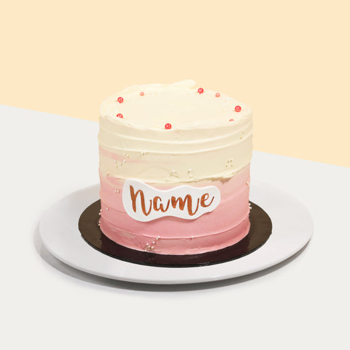 Pink ombre cake with a customizable name on the side
