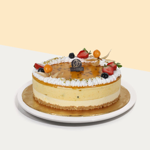 Passionfruit cheesecake with biscuit base, topped with passionfruit jelly, fresh cream and fruits