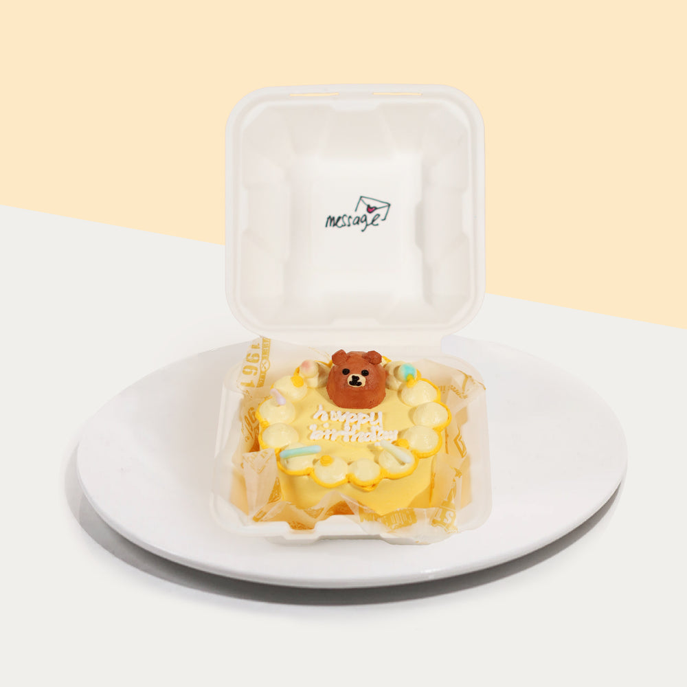 Bento cake with yellow buttercream, and a piped bear on top