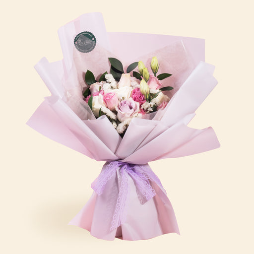 Bouquet with purple roses, white roses and pink eustomas