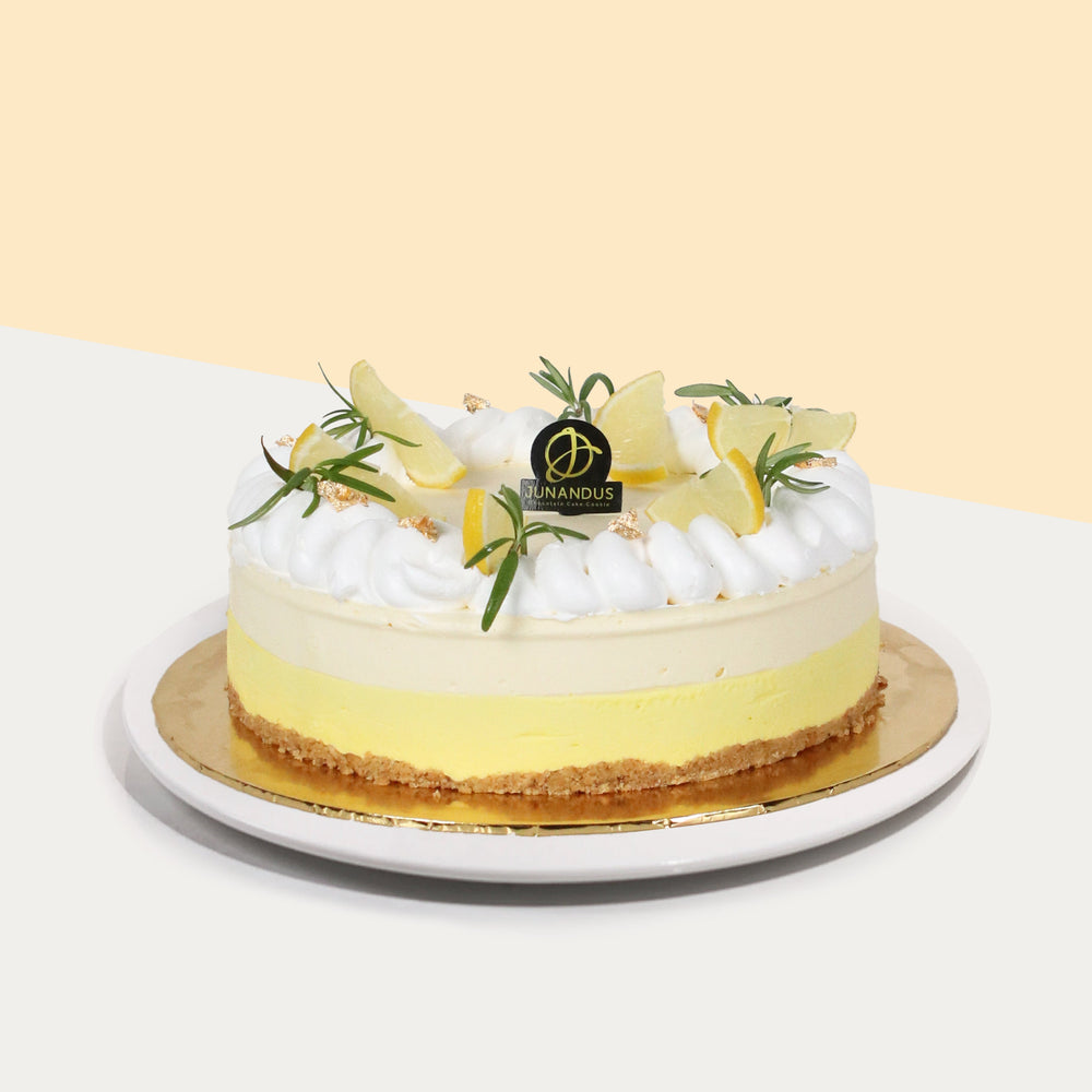 Lemon cheesecake with crunchy biscuit base, topped with fresh cream, rosemary and lemon slices