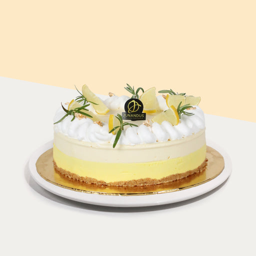Lemon cheesecake with crunchy biscuit base, topped with fresh cream, rosemary and lemon slices