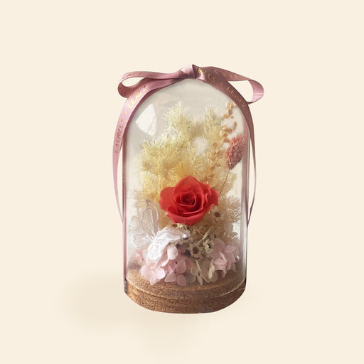 Preserved roses and flowers in a see through bell jar