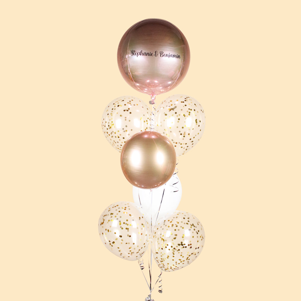 Metallic rose gold Orbz  balloon, along with confetti and white balloons