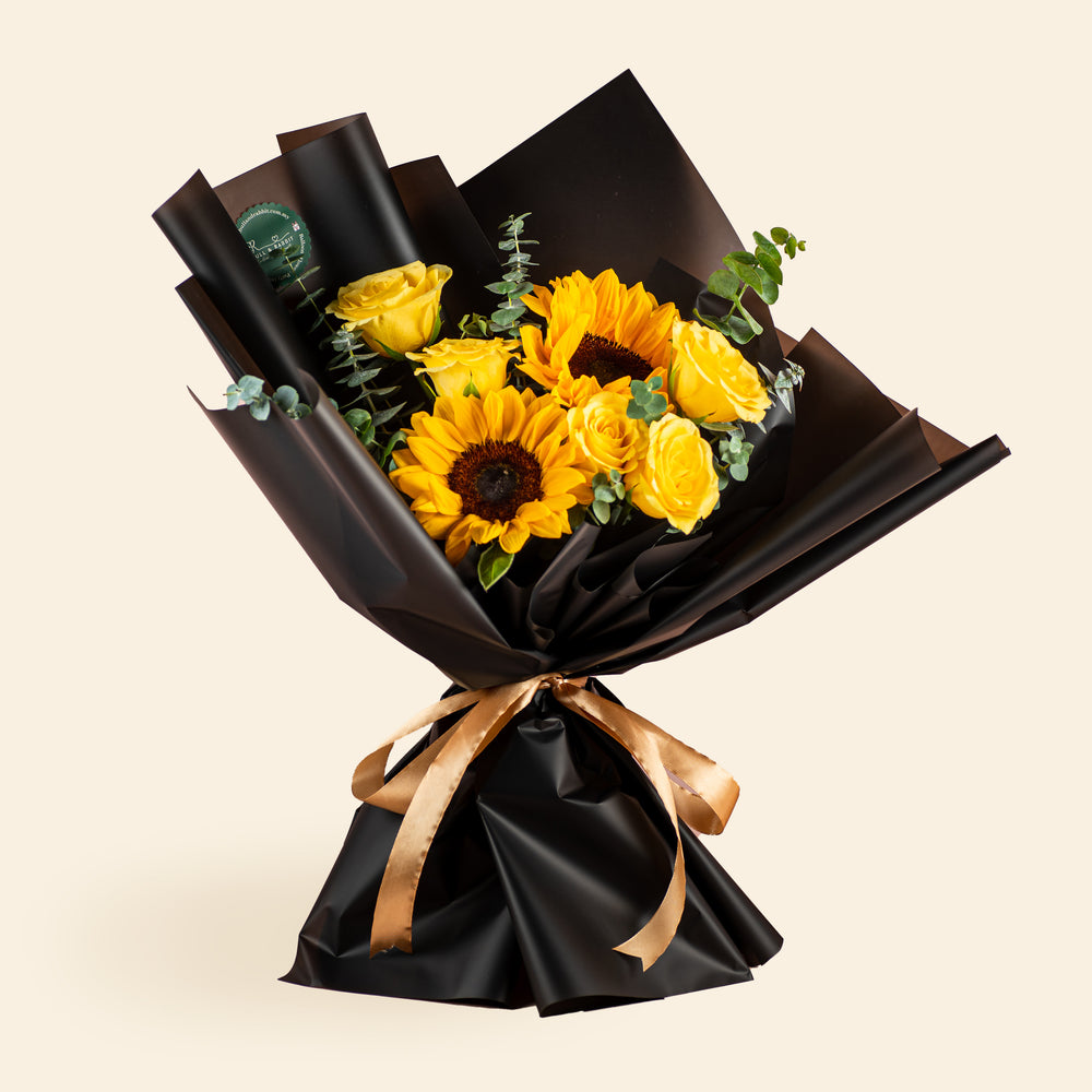 Sunflower, yellow rose and eucalyptus bouquet wrapped in black paper