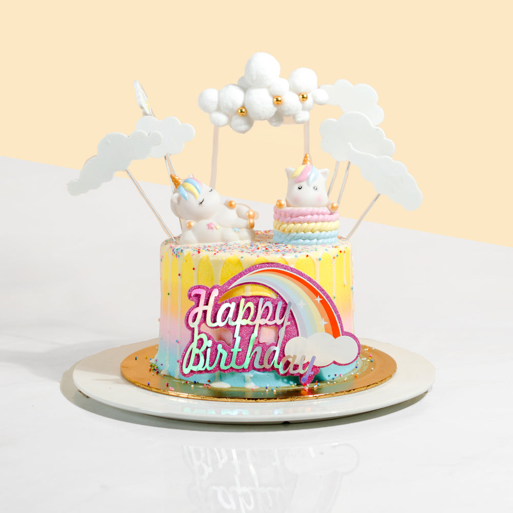 Rainbow coloured buttercream cake, with unicorn decorations