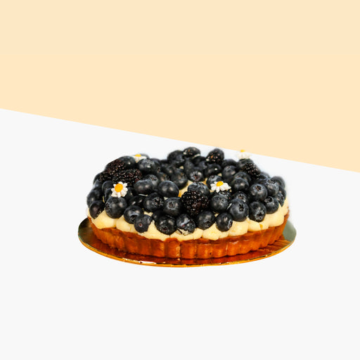 Fruit tart filled with almond Frangipane, topped with fresh blueberries and black raspberries