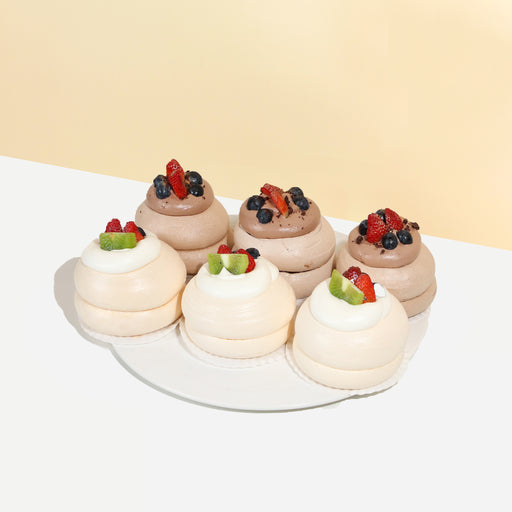 Mini pavlovas topped with cream and fresh fruits
