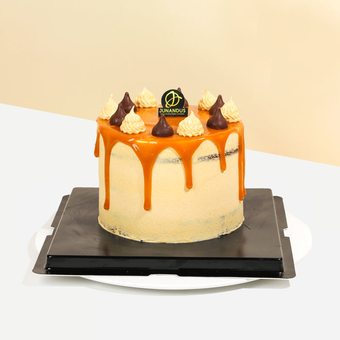 Chocolate cake frosted with cream, with caramel drips
