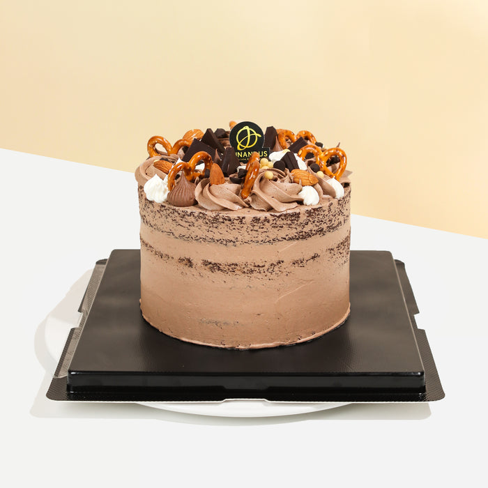 Hazelnut chocolate cake with Hershey Kisses, pretzels, and hazelnut cream