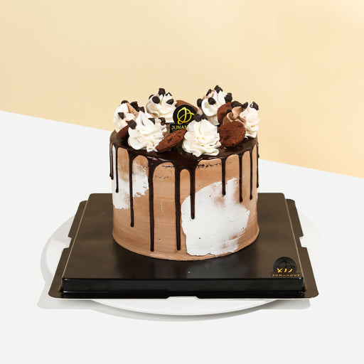 Chocolate cake with Chipsmore pieces, with chocolate drip running down the sides