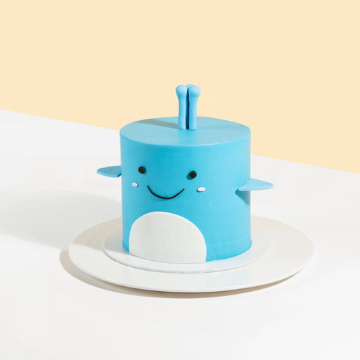 Cute blue whale cake with a smiley face