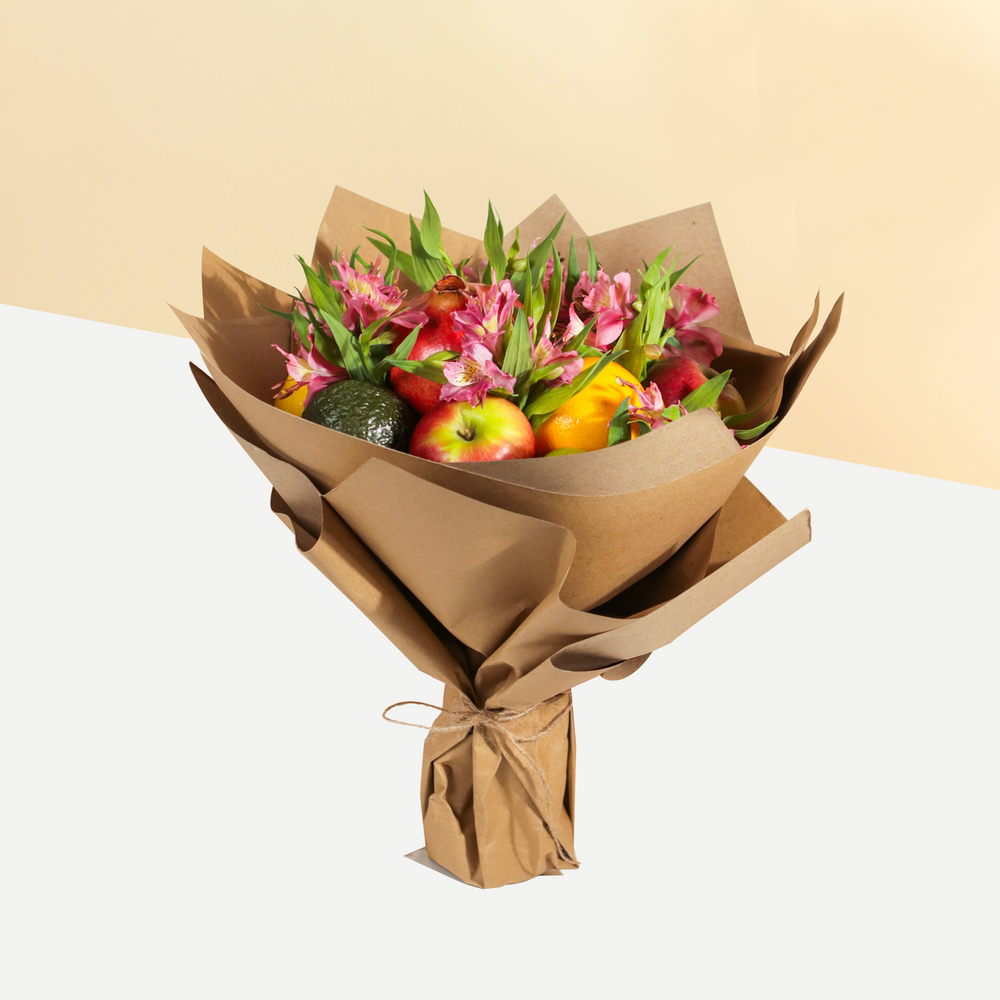 Fruits bouquet with alstromeria flowers, in a rustic brown wrapper