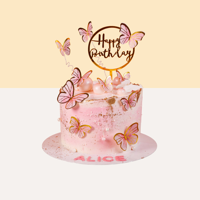 Pink buttercream cake, topped with sparkling butterflies