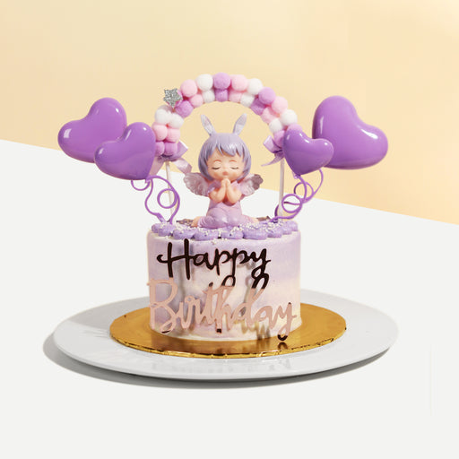Purple buttercream cake, with a girl figurine and purple hearts decoration