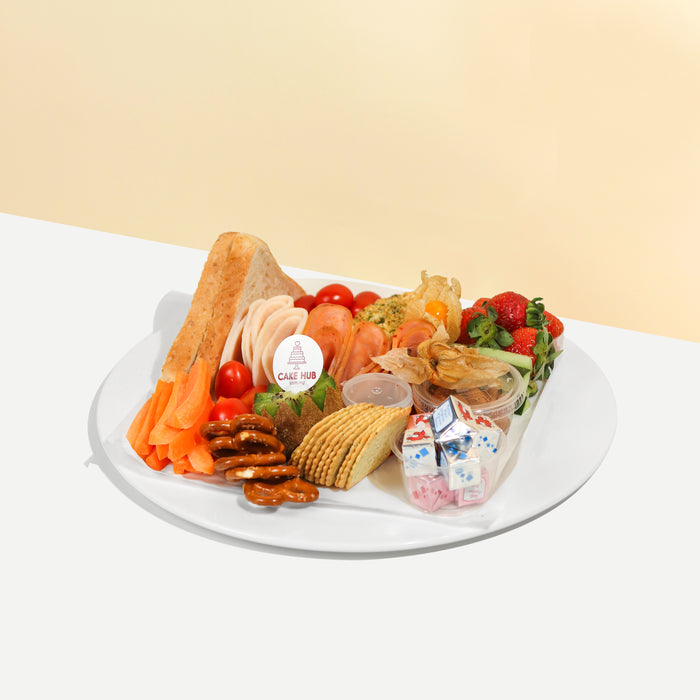 Breakfast platter with bread, baguette, crackers, pretzels, fruits, vegetables and cold cuts