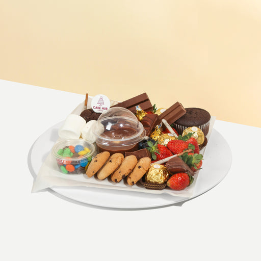 Chocolate platter with Kinder Bueno, KitKats, M&Ms, Ferrero Rocher, marshmallows, cookies and strawberries