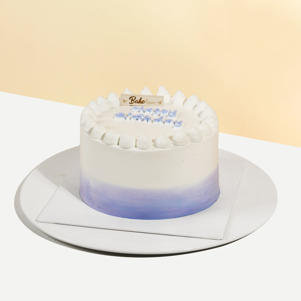 Ombre cake with purple and white accents, filled with yam