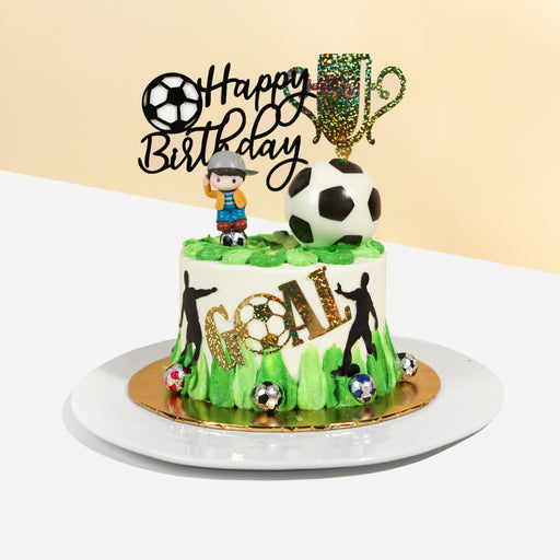Football themed cake with green and white buttercream, along with chocolate soccer balls